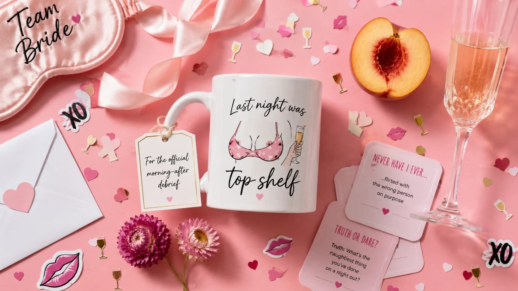 Funny bachelorette gift flat lay with a cheeky mug, party game cards, champagne and pink decorations