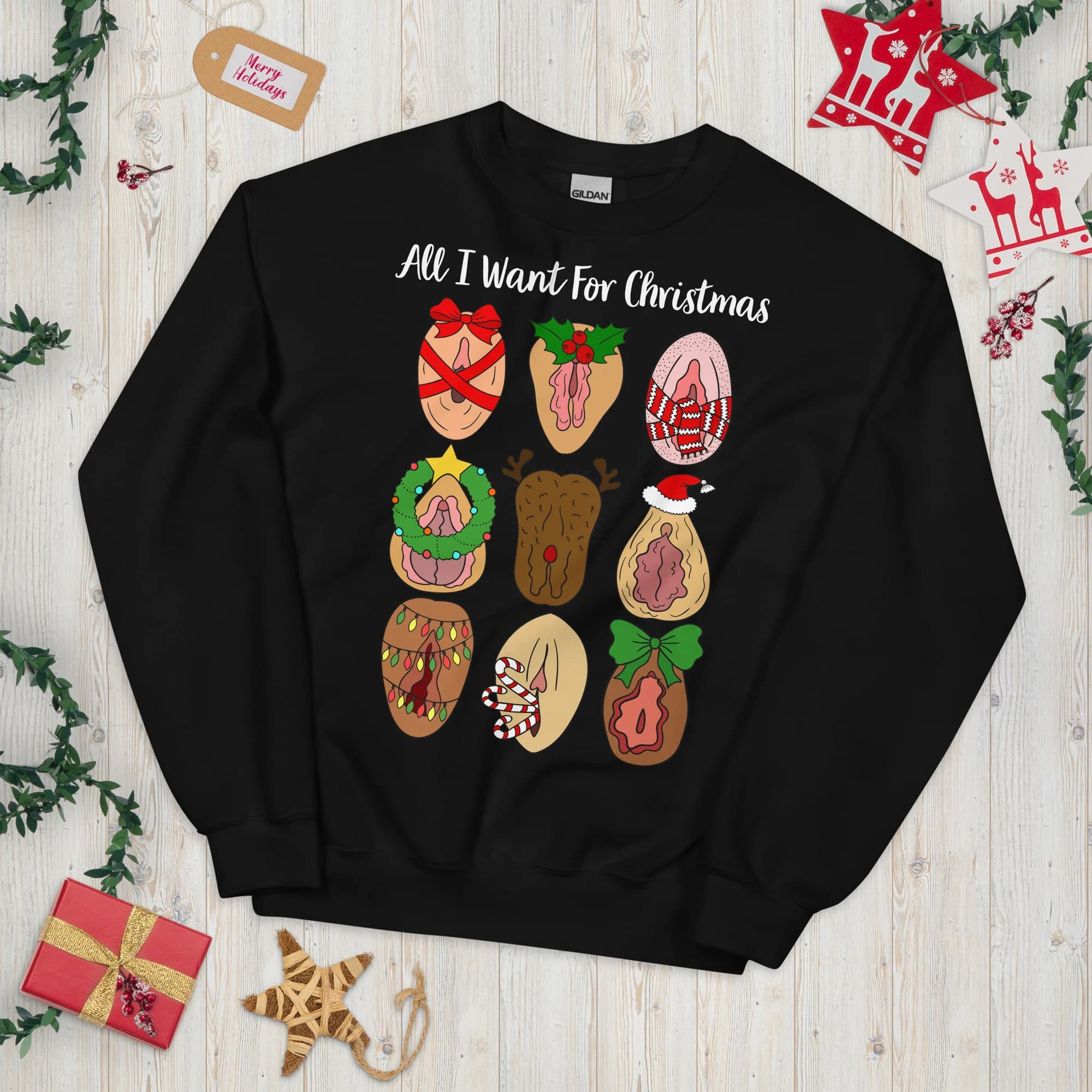 Black crewneck sweatshirt laid flat with nine festive vulva illustrations and sample 'All I Want For Christmas' text.